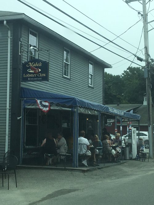 Diners on the covered porch of Mabel's Lobster Claw restaurant