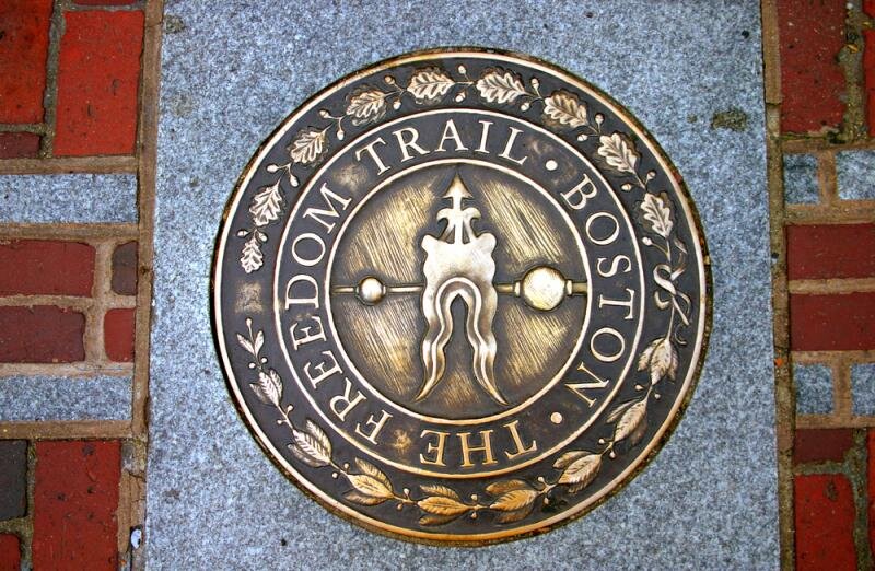 Freedom Trail medallion set in a brick sidewalk