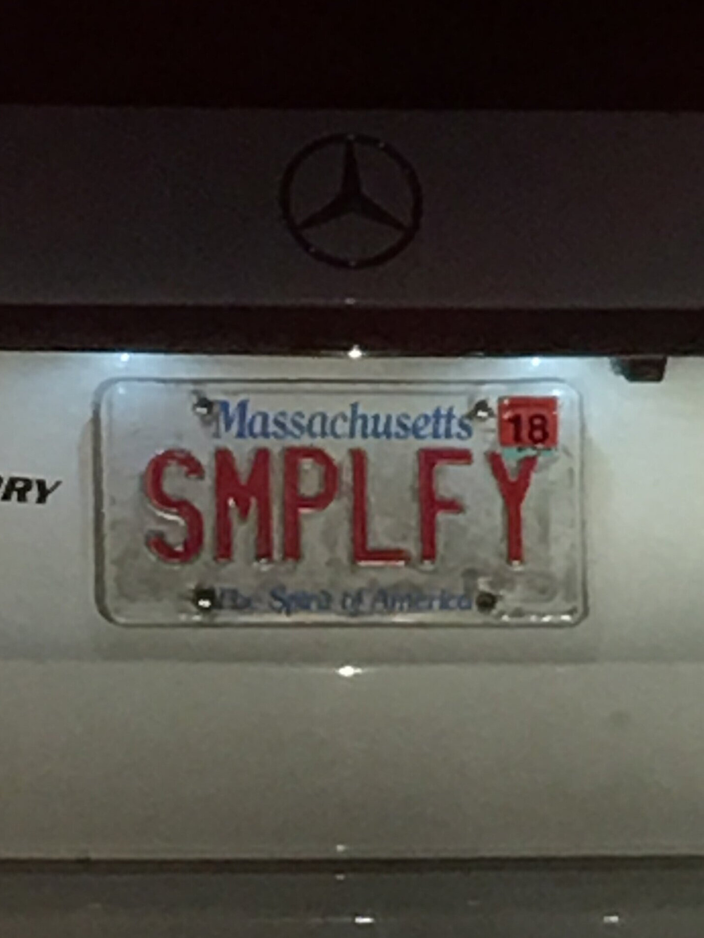Massachusetts license plate reading "SMPLFY"