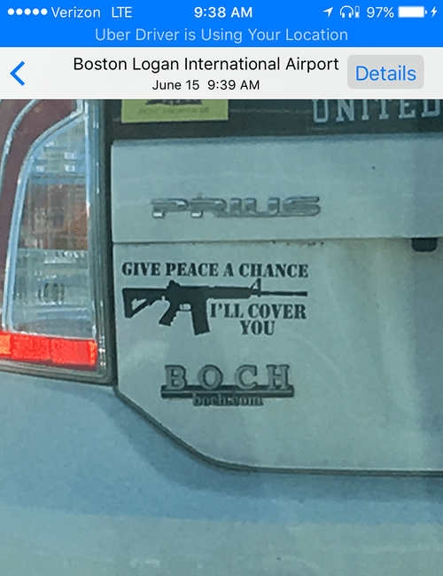 "Give peace a chance, I'll cover you" bumper sticker with a rifle on a Prius