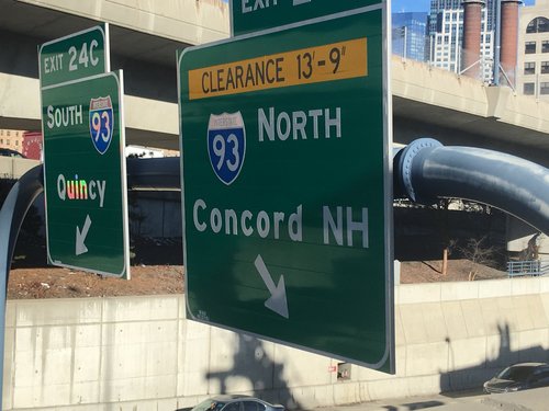 Highway signs for I-93 North to Concord, NH and South to Quincy