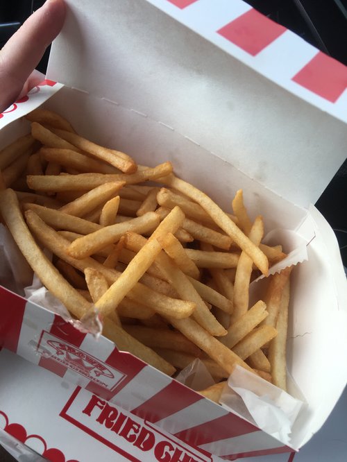 French fries in a red and white fried chicken box
