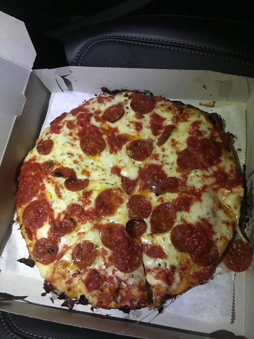 Pepperoni pizza in an open box