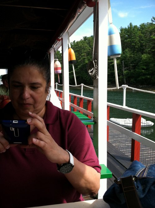 Woman taking a photo at an outdoor lobster pier