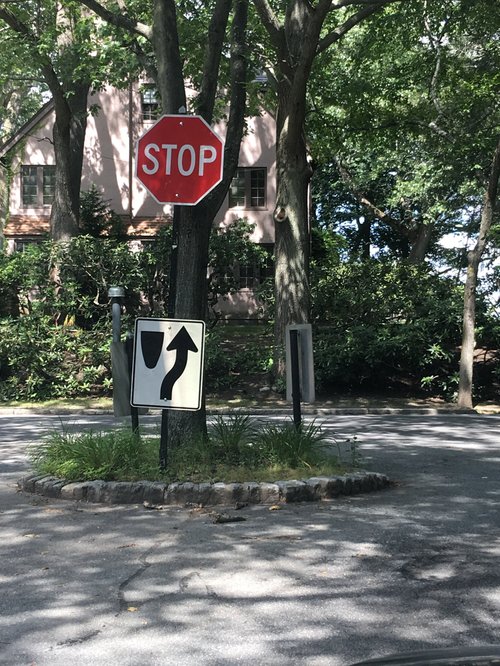 Stop sign and keep-right sign at a small traffic island