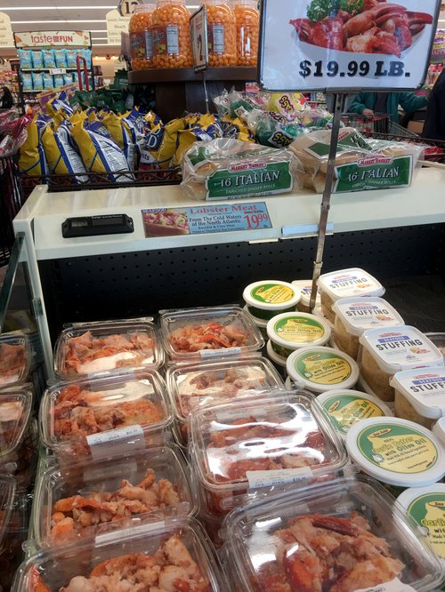 Supermarket display of packaged lobster meat at $19.99 a pound