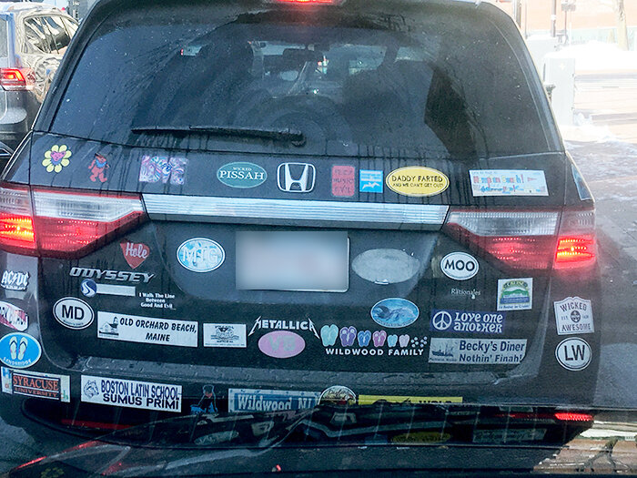 Minivan covered in bumper stickers