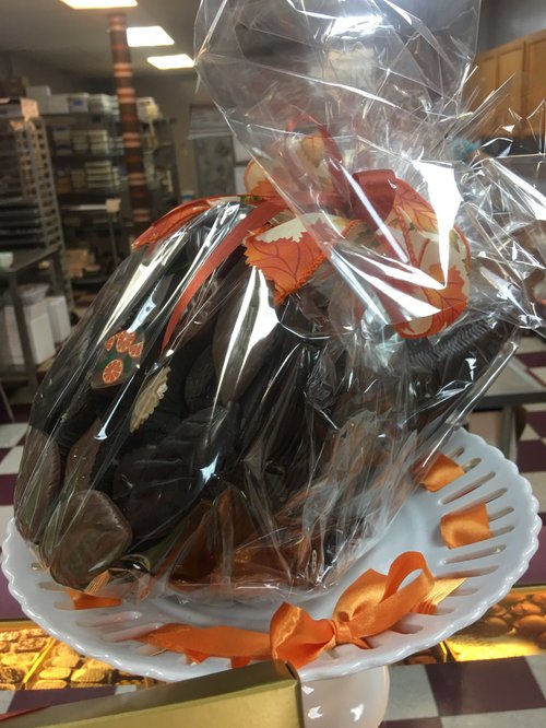 Chocolate gift wrapped in cellophane with an orange bow