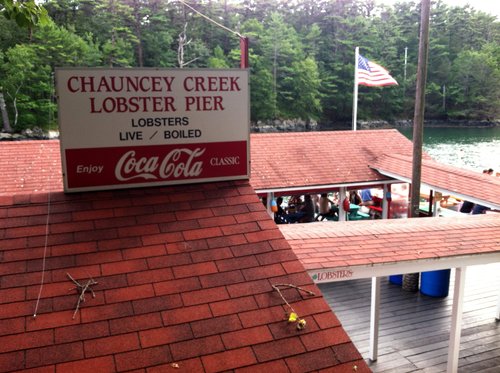Chauncey Creek Lobster Pier sign above its red-roofed deck