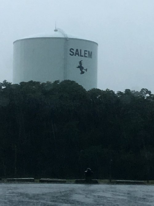 Salem water tower with a witch logo on a misty day