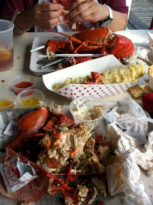 Half-eaten lobster dinner with shells on the table