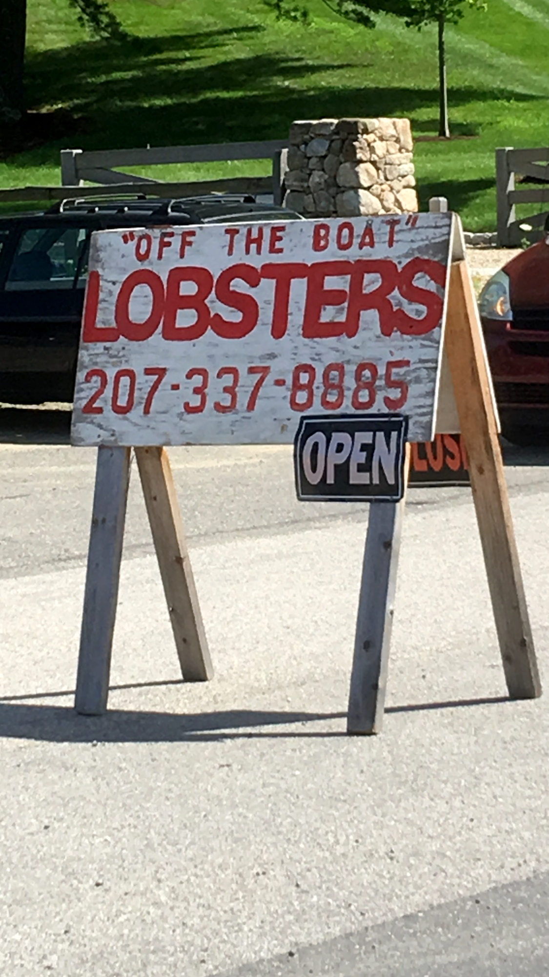 Roadside sign: "Off the boat" lobsters, open
