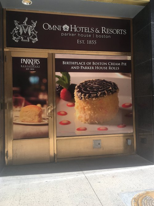 Omni Parker House entrance with a Boston cream pie poster