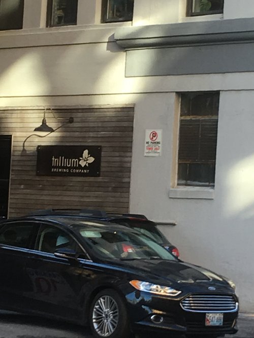Trillium Brewing Company sign above a parked car