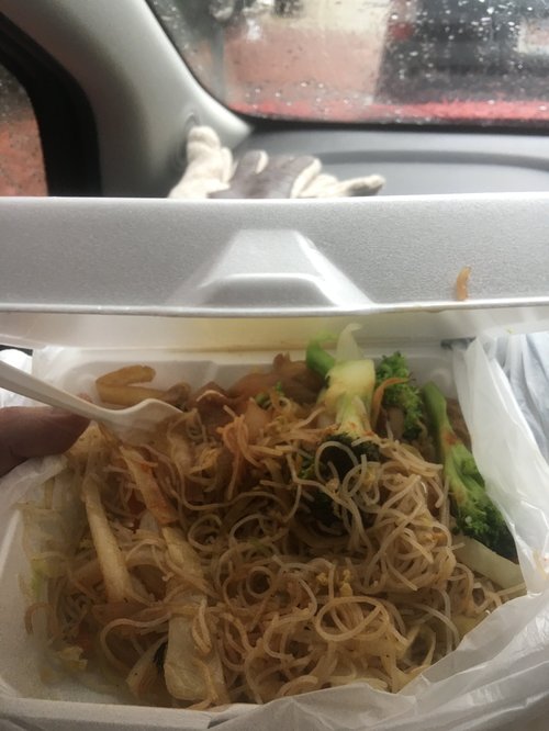 Takeout noodles with broccoli in a foam container