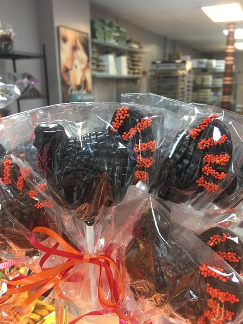 Halloween chocolate lollipops decorated with orange sprinkles