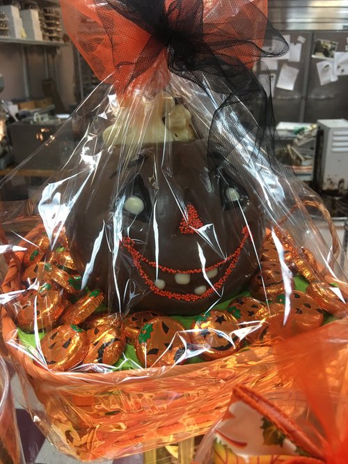Chocolate jack-o'-lantern wrapped in an orange Halloween basket