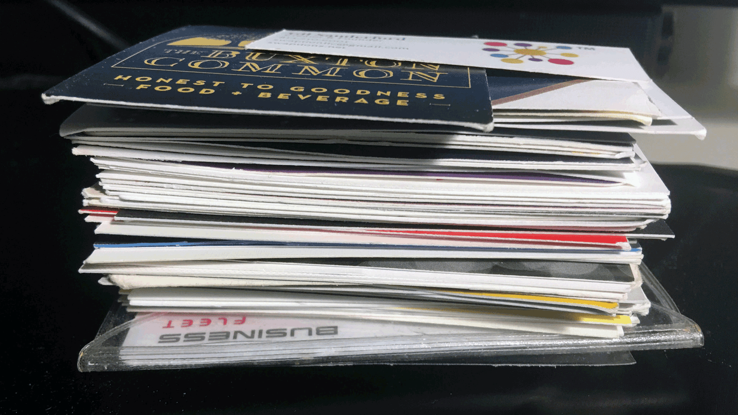 Stack of business cards collected from riders