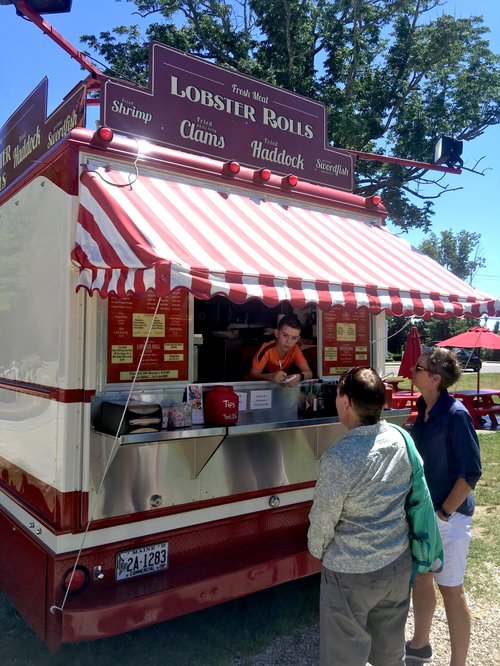 Customers at the window of the Lobster Rolls food truck