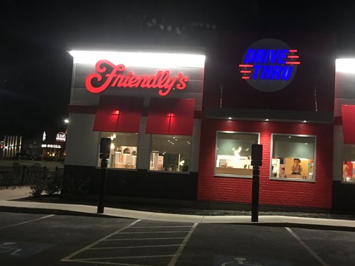 Friendly's restaurant with a drive-thru sign at night