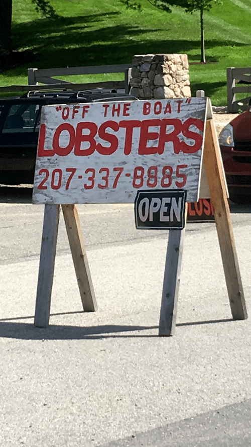 Roadside sign: "Off the boat" lobsters, open