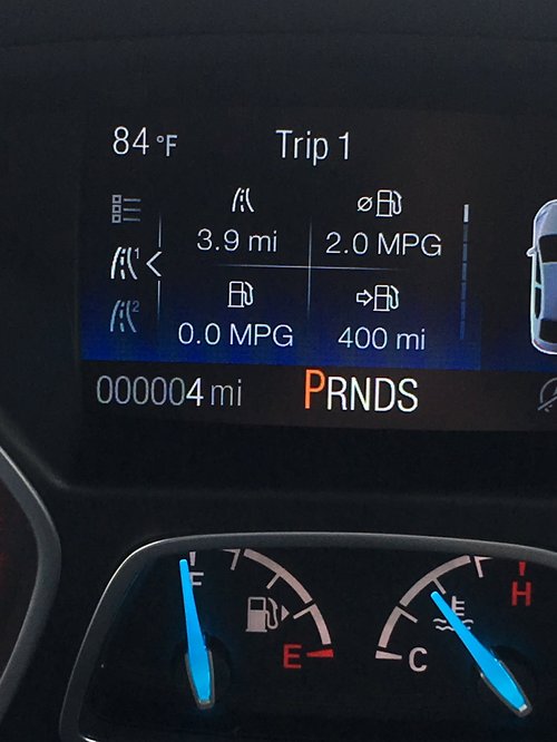 Car dashboard showing 4 miles on the odometer and 400 miles of range