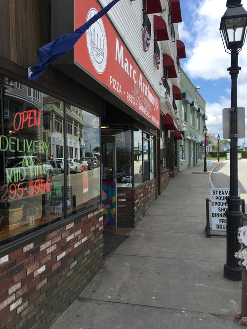 Marc Anthony's pizza shop on a sidewalk