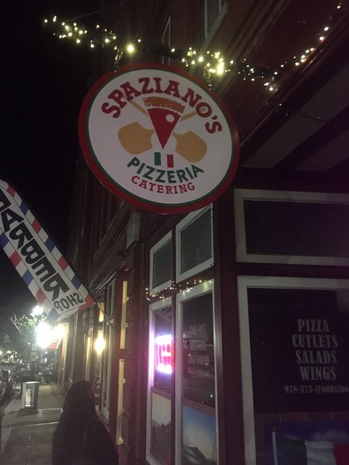 Spaziano's Pizzeria sign lit at night