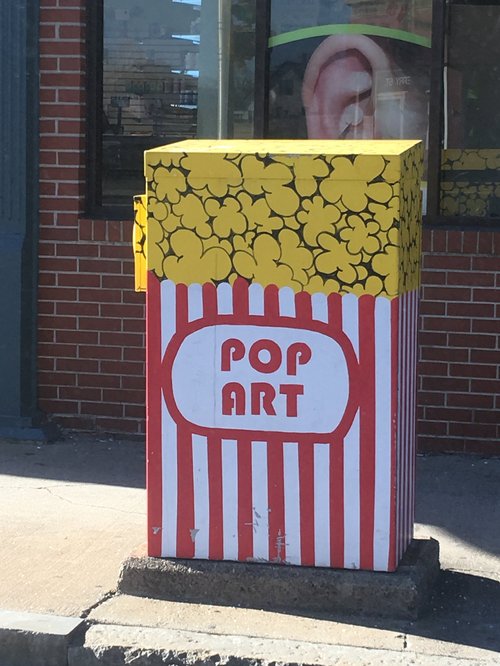 Utility box painted as a popcorn box reading "Pop Art"
