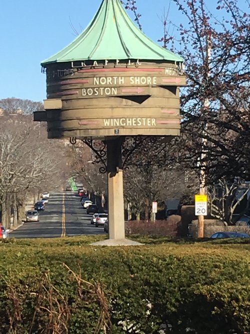 Old wooden direction sign pointing to Boston, the North Shore and Winchester