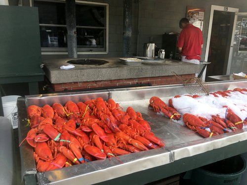 Cooked lobsters on ice at an outdoor counter