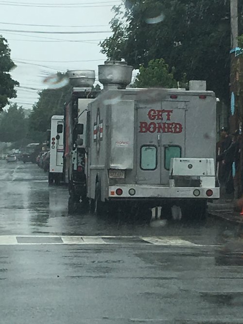 "Get Boned" food truck on a rainy street
