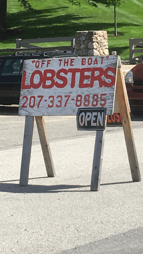 Roadside sign: "Off the boat" lobsters, open