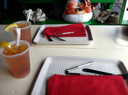 Iced tea and lobster crackers on a picnic table